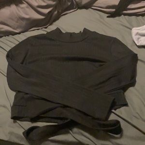 Black turtleneck crop top. wrap around at bottom.